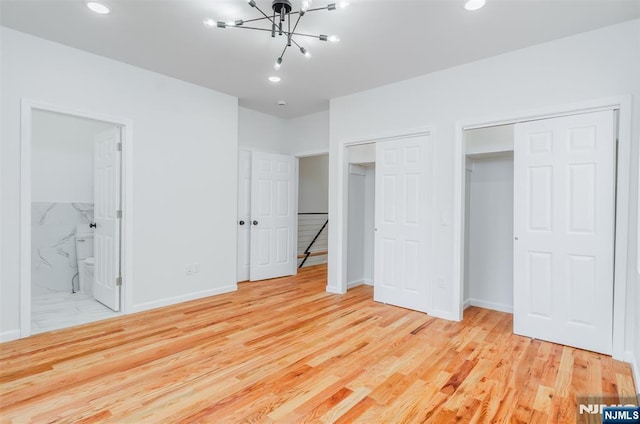 85 Myrtle Ave, Jersey City, NJ 07305 - unfurnished bedroom with two closets, a chandelier, wood finished floors, baseboards, and recessed lighting