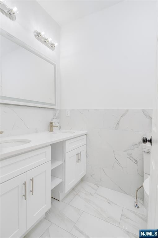 85 Myrtle Ave, Jersey City, NJ 07305 - full bathroom featuring double vanity, marble finish floors, and tile walls