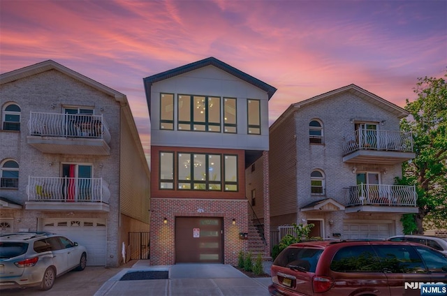 85 Myrtle Ave, Jersey City, NJ 07305 - view of front of home with a garage, brick siding, and driveway