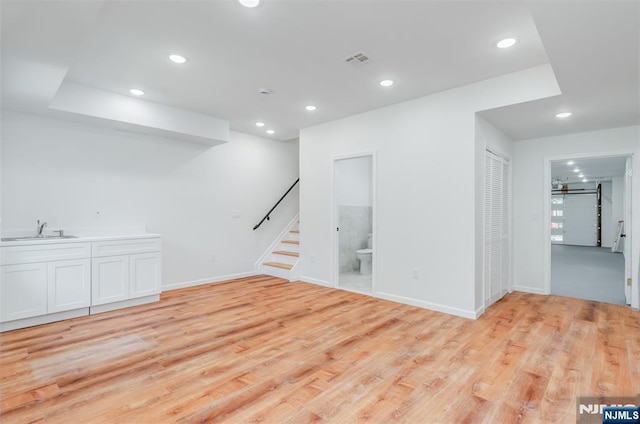 85 Myrtle Ave, Jersey City, NJ 07305 - basement featuring a sink, recessed lighting, light wood-style floors, stairs, and baseboards