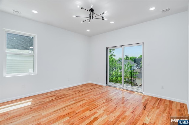 85 Myrtle Ave, Jersey City, NJ 07305 - unfurnished room with wood finished floors, a chandelier, baseboards, and recessed lighting