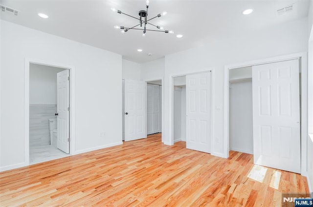 85 Myrtle Ave, Jersey City, NJ 07305 - unfurnished bedroom featuring light wood-style flooring, multiple closets, a chandelier, recessed lighting, and baseboards