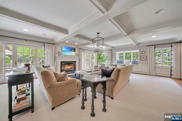 76 Wildwood Rd, Ridgewood, NJ 07450 - living area with coffered ceiling, beam ceiling, a glass covered fireplace, crown molding, and carpet flooring