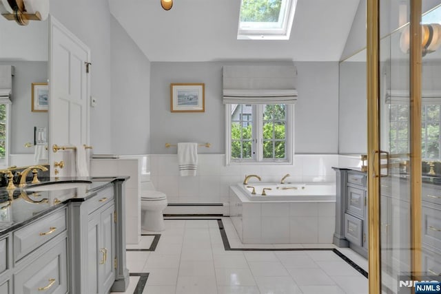 76 Wildwood Rd, Ridgewood, NJ 07450 - bathroom with a skylight, a baseboard radiator, vanity, tile patterned flooring, and a garden tub