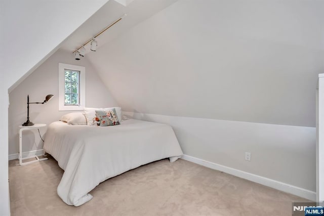 76 Wildwood Rd, Ridgewood, NJ 07450 - bedroom featuring vaulted ceiling, baseboards, light colored carpet, and track lighting