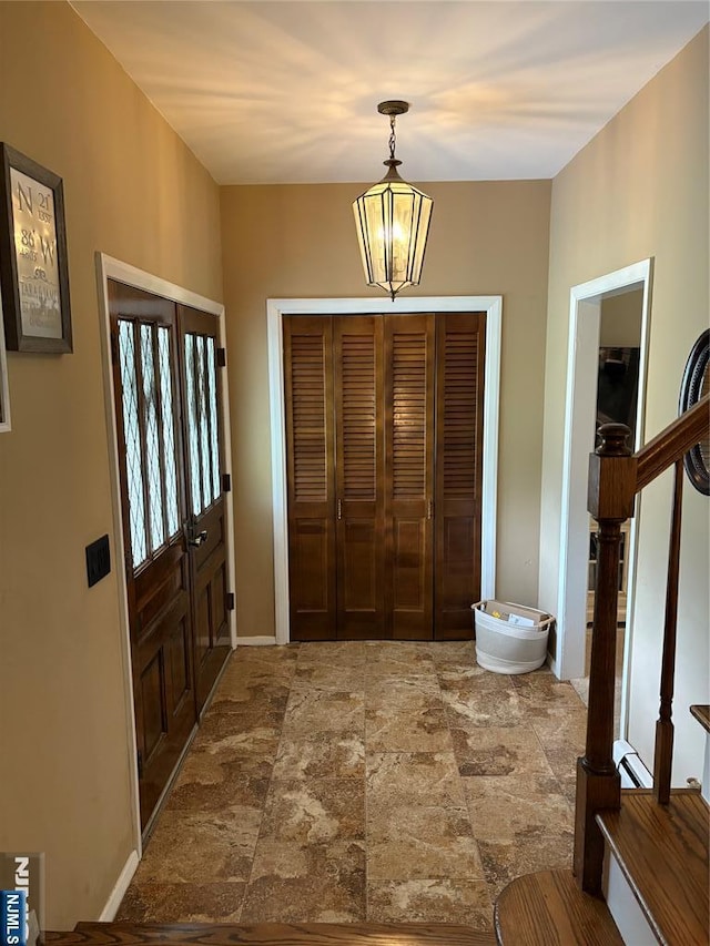 32 Northgate, Wanaque, NJ 07465 - entryway with stone finish flooring, stairs, and baseboards