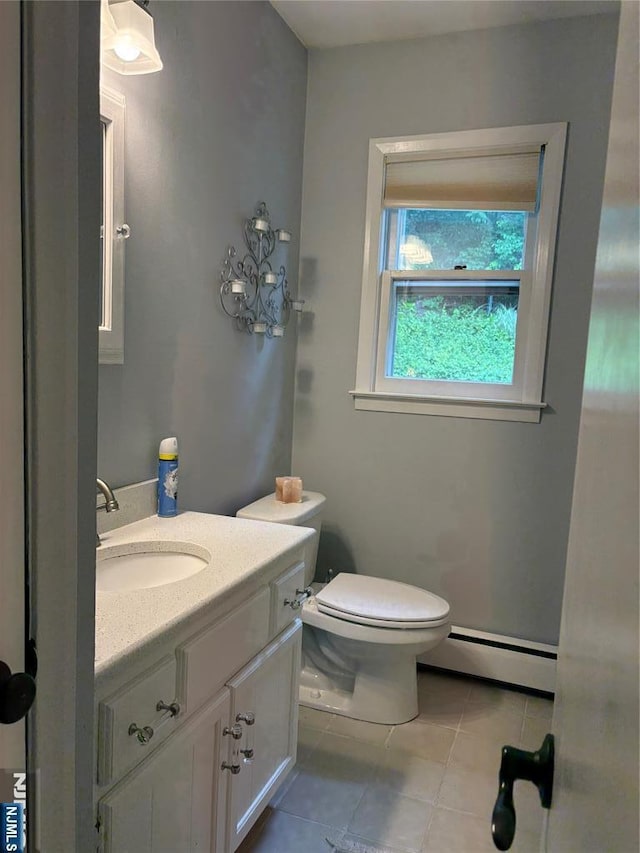 32 Northgate, Wanaque, NJ 07465 - half bath featuring a baseboard radiator, vanity, tile patterned flooring, and toilet