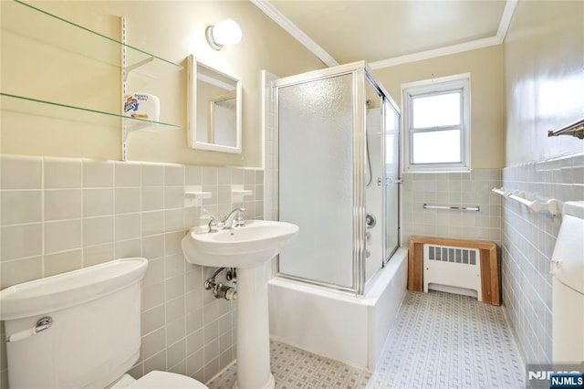 2350 Linwood Ave Unit 4D, Fort Lee, NJ 07024 - bathroom featuring radiator heating unit, tile walls, toilet, crown molding, and combined bath / shower with glass door