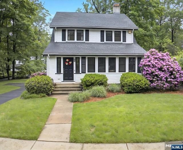 246 Park Ave, Allendale, NJ 07401 - view of front facade with a chimney, a front yard, and roof with shingles