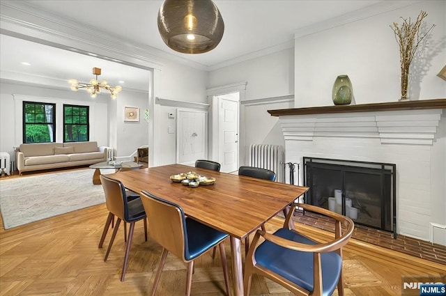 246 Park Ave, Allendale, NJ 07401 - dining room with radiator, crown molding, a fireplace, and a chandelier
