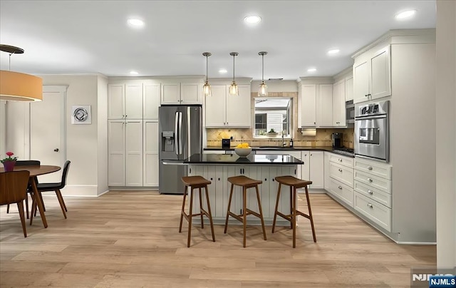 246 Park Ave, Allendale, NJ 07401 - kitchen featuring appliances with stainless steel finishes, dark countertops, light wood finished floors, a breakfast bar, and recessed lighting