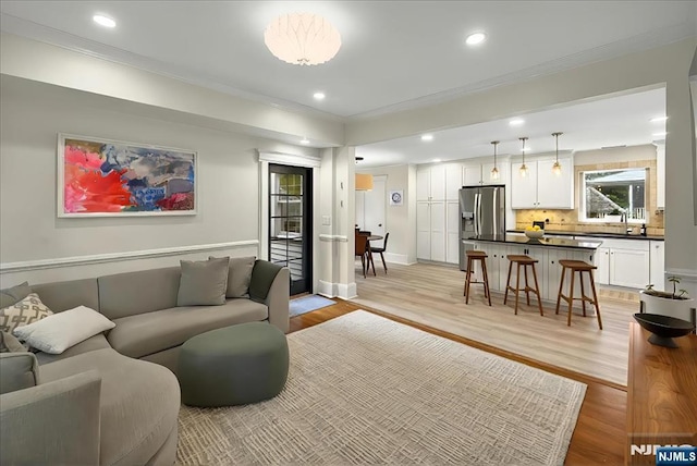 246 Park Ave, Allendale, NJ 07401 - living room with light wood-type flooring, recessed lighting, baseboards, and crown molding