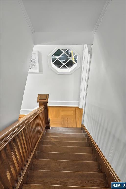 246 Park Ave, Allendale, NJ 07401 - stairway with wood finished floors and ornamental molding