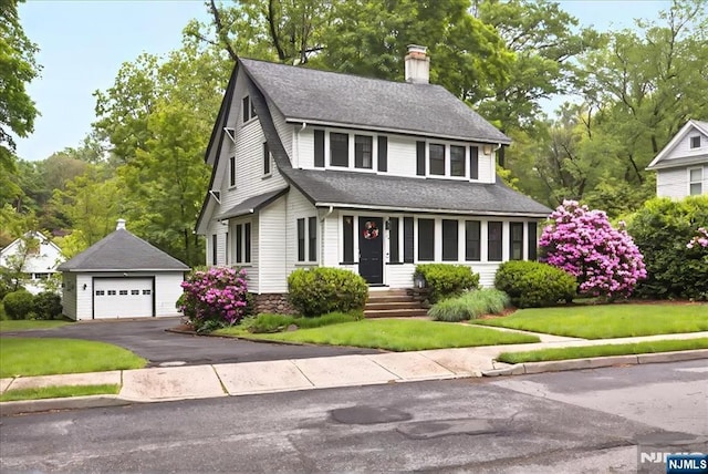 246 Park Ave, Allendale, NJ 07401 - view of front facade featuring an outdoor structure, a garage, a chimney, a shingled roof, and a front yard