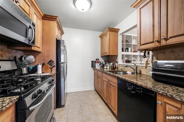 270 Grand Ave Unit 4E, Palisades Park, NJ 07650 - kitchen with appliances with stainless steel finishes, a sink, decorative backsplash, dark stone countertops, and baseboards