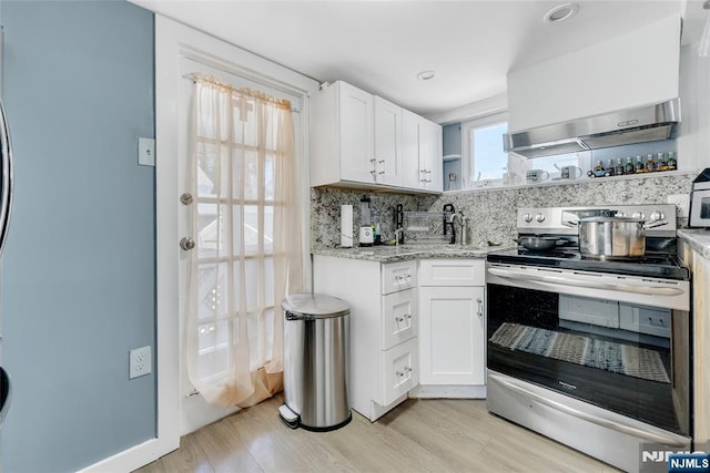 18 Tromp St, Clifton, NJ 07011 - kitchen with stainless steel range with electric cooktop, open shelves, white cabinets, light wood-type flooring, and light stone countertops
