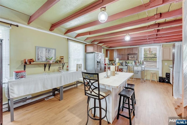 18 Tromp St, Clifton, NJ 07011 - kitchen featuring stainless steel fridge, beamed ceiling, light countertops, healthy amount of natural light, and light wood finished floors