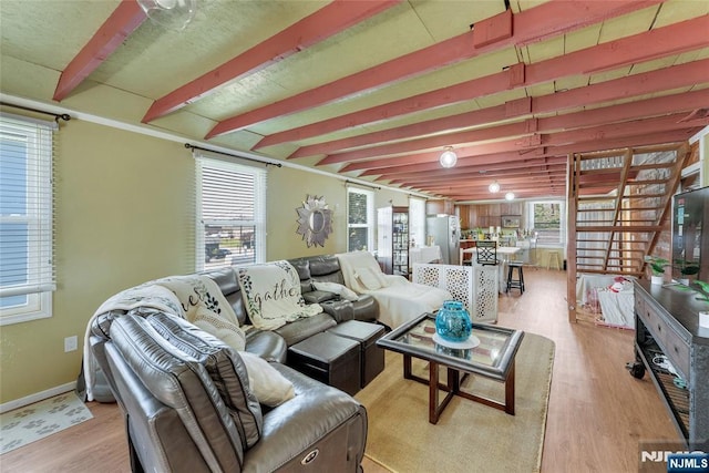 18 Tromp St, Clifton, NJ 07011 - living area with light wood-style flooring, healthy amount of natural light, beam ceiling, and baseboards