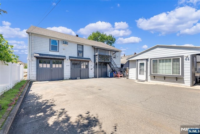 18 Tromp St, Clifton, NJ 07011 - view of front of property with an attached garage, driveway, and stairway