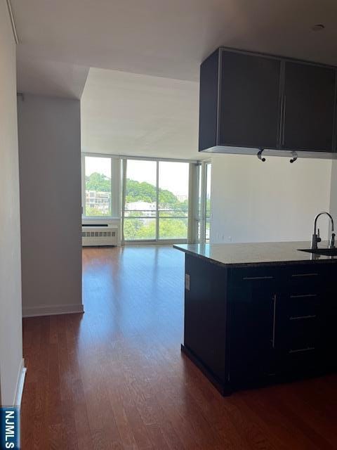 615 Hudson Park, Edgewater, NJ 07020 - kitchen with dark cabinetry, a sink, dark wood finished floors, open floor plan, and radiator