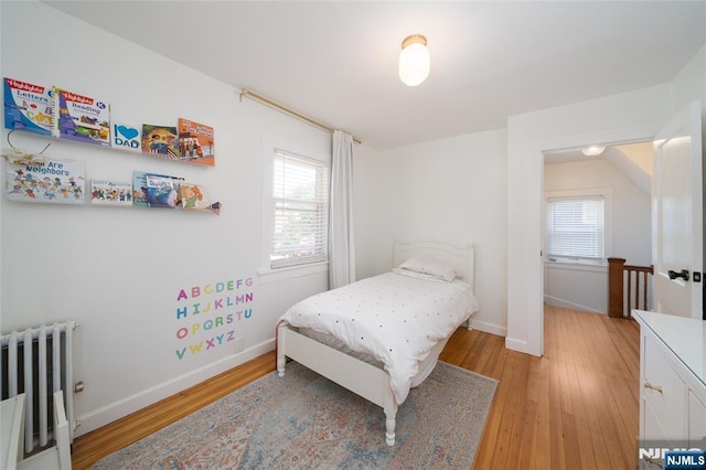1096 Stasia St, Teaneck, NJ 07666 - bedroom with radiator, multiple windows, light wood-style floors, and baseboards