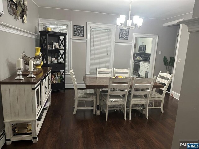 140 Oak St, Paterson, NJ 07501 - dining area featuring a chandelier, dark wood-type flooring, and baseboard heating