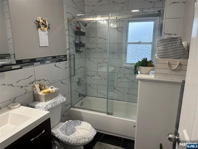 140 Oak St, Paterson, NJ 07501 - full bathroom featuring tile walls, bath / shower combo with glass door, vanity, and toilet