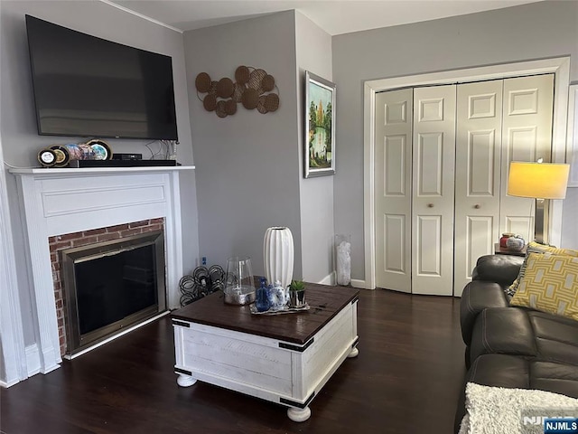 140 Oak St, Paterson, NJ 07501 - living area with dark wood-style floors, a fireplace, and baseboards
