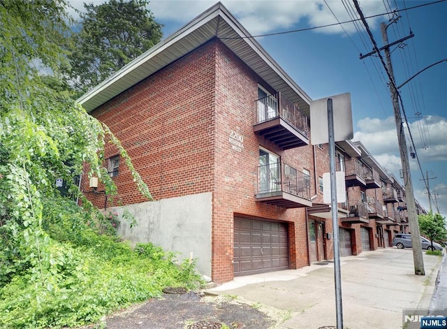 2200 Paterson Plank Rd Unit 19, North Bergen, NJ 07047 - view of building exterior featuring an attached garage and driveway