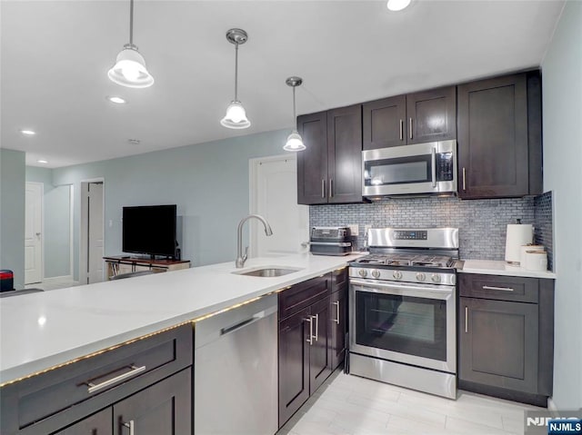 2200 Paterson Plank Rd Unit 19, North Bergen, NJ 07047 - kitchen with appliances with stainless steel finishes, a sink, light countertops, tasteful backsplash, and pendant lighting