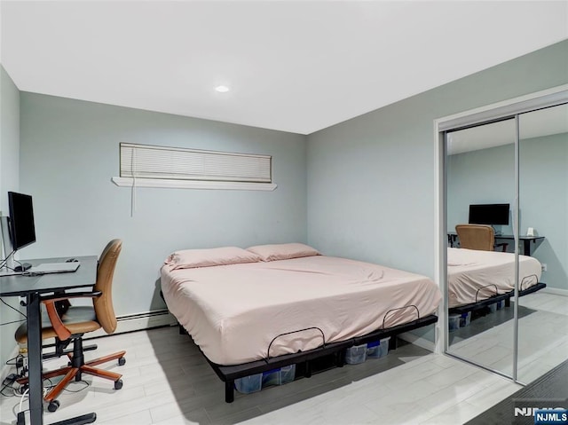 2200 Paterson Plank Rd Unit 19, North Bergen, NJ 07047 - bedroom featuring a closet, a desk, recessed lighting, light wood-style floors, and baseboards