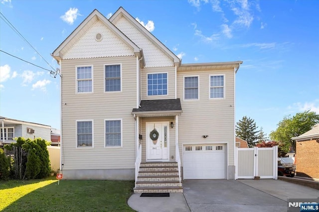 861 Birch St, Perth Amboy, NJ 08861 - view of front facade with an attached garage, concrete driveway, and a gate