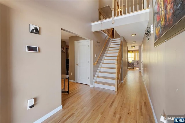 861 Birch St, Perth Amboy, NJ 08861 - staircase featuring baseboards, wood finished floors, and a towering ceiling