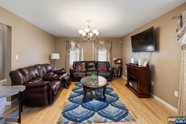 861 Birch St, Perth Amboy, NJ 08861 - living room with a chandelier, light wood finished floors, and baseboards