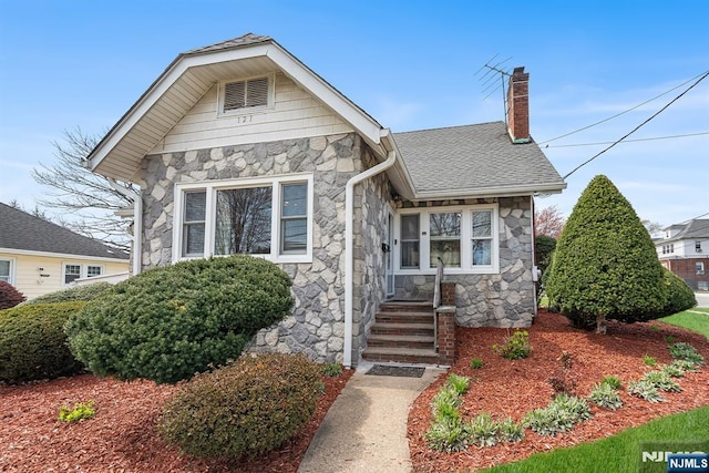 121 Summit Ave, Lyndhurst, NJ 07071 - bungalow-style home featuring stone siding, a chimney, and a shingled roof