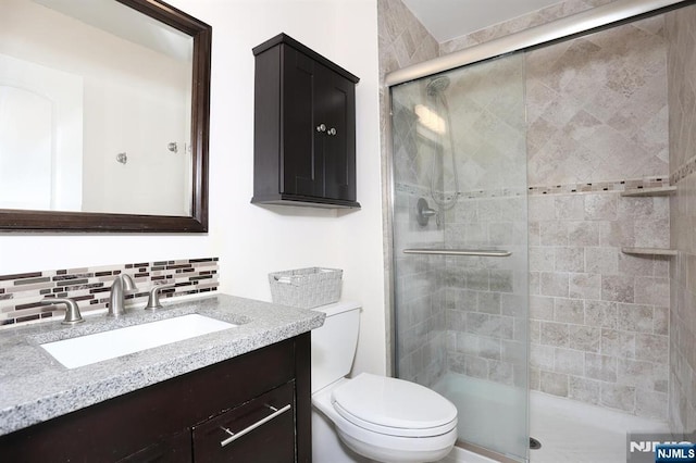 250 Gorge Rd Unit 12F, Cliffside Park, NJ 07010 - full bathroom with toilet, vanity, a stall shower, and backsplash