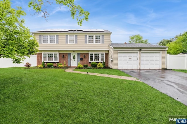 1 Webster Rd, Franklin, NJ 08873 - colonial home featuring driveway, an attached garage, solar panels, and brick siding