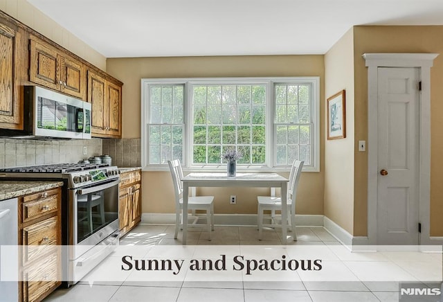 640 E Glen Ave, Ridgewood, NJ 07450 - kitchen featuring appliances with stainless steel finishes, brown cabinetry, tasteful backsplash, and baseboards