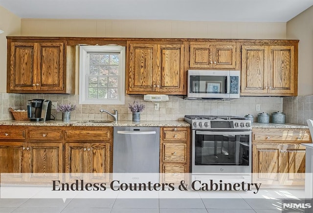 640 E Glen Ave, Ridgewood, NJ 07450 - kitchen with appliances with stainless steel finishes, brown cabinetry, and a sink