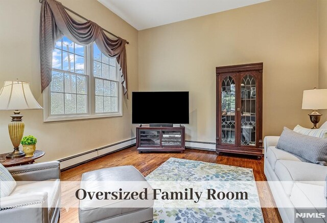 640 E Glen Ave, Ridgewood, NJ 07450 - living area featuring a baseboard radiator, plenty of natural light, and wood finished floors