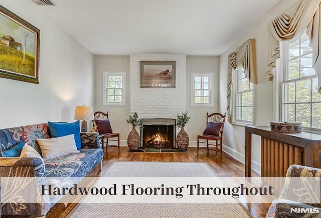 640 E Glen Ave, Ridgewood, NJ 07450 - living room featuring plenty of natural light, hardwood / wood-style flooring, a brick fireplace, and baseboards
