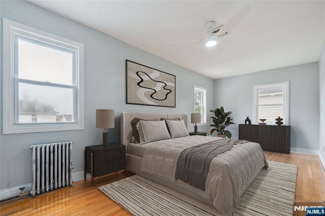 1153 Margaret St, Teaneck, NJ 07666 - bedroom with radiator, light wood-style flooring, baseboards, and ceiling fan