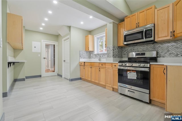 1153 Margaret St, Teaneck, NJ 07666 - kitchen featuring appliances with stainless steel finishes, decorative backsplash, light countertops, baseboards, and recessed lighting