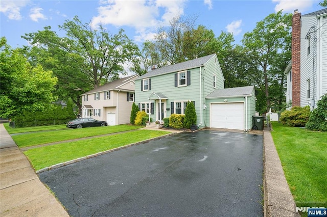 18 Cadmus St, Nutley, NJ 07110 - colonial inspired home featuring a garage, driveway, and a front yard