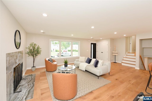 15-22 Radburn Rd, Fair Lawn, NJ 07410 - living room with stairway, a high end fireplace, recessed lighting, and light wood finished floors