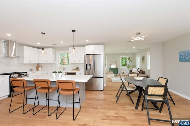 15-22 Radburn Rd, Fair Lawn, NJ 07410 - kitchen featuring stainless steel appliances, wall chimney range hood, a center island, white cabinets, and recessed lighting