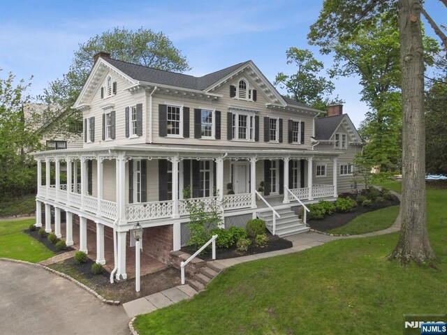 249 Valley Rd, Montclair, NJ 07042 - view of front of house with a porch, a chimney, and a front lawn