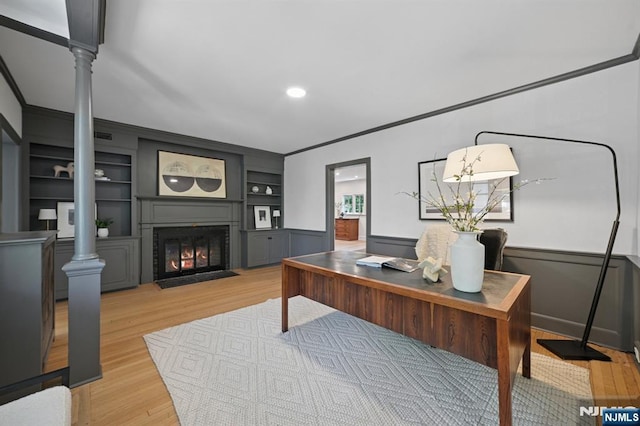 249 Valley Rd, Montclair, NJ 07042 - office space featuring ornate columns, a fireplace with flush hearth, light wood-type flooring, ornamental molding, and built in features
