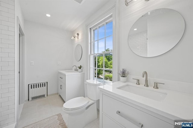 249 Valley Rd, Montclair, NJ 07042 - full bath featuring radiator, two vanities, tile patterned flooring, toilet, and recessed lighting
