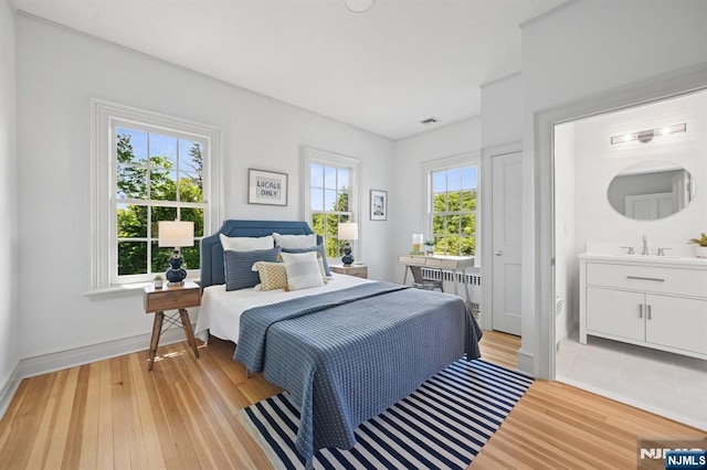249 Valley Rd, Montclair, NJ 07042 - bedroom with light wood-style floors, baseboards, and a sink